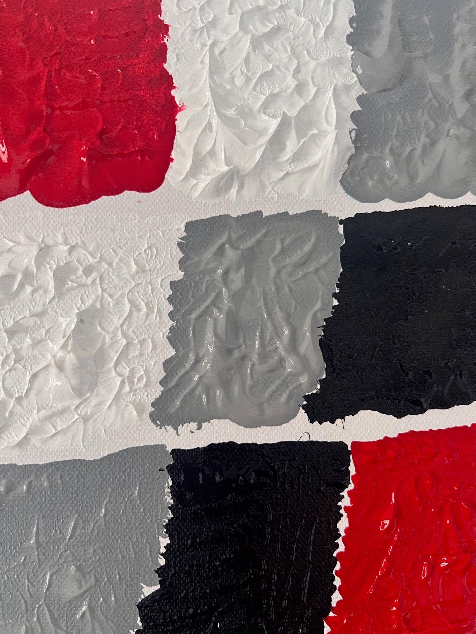 détail rouge vif intense tableau abstrait moderne en relief damier  noir gris 